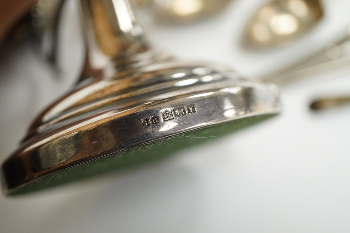 A small group of silver including a modern two branch, three light dwarf candelabrum by Sanders & Mackenzie, height 10.2cm, weighted, a pair of handled glove stretchers and eight small items of flatware.